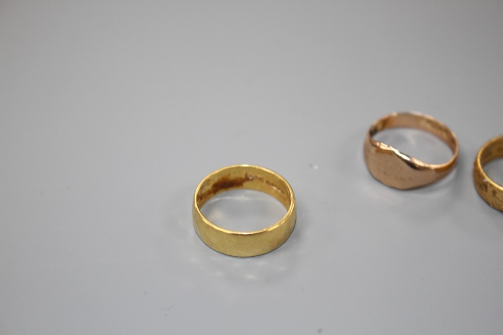 Two 22ct gold wedding bands and a 9ct gold signet ring, 9ct 2.5 grams, 22ct 11 grams.